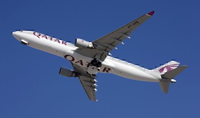 Qatar airliner take-off against blue sky