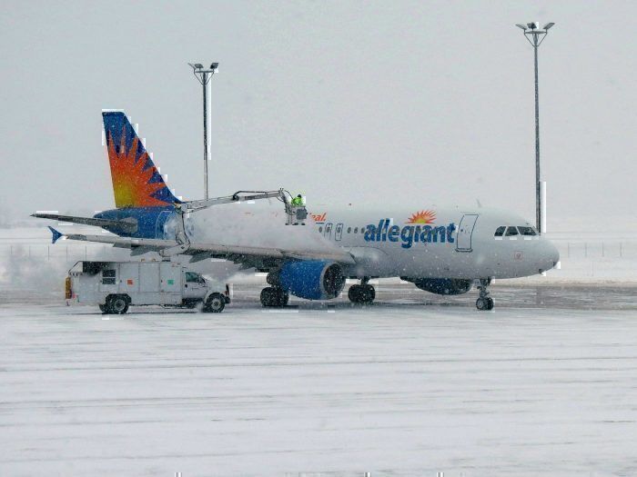 Allegiant airliner in snow on taxiway