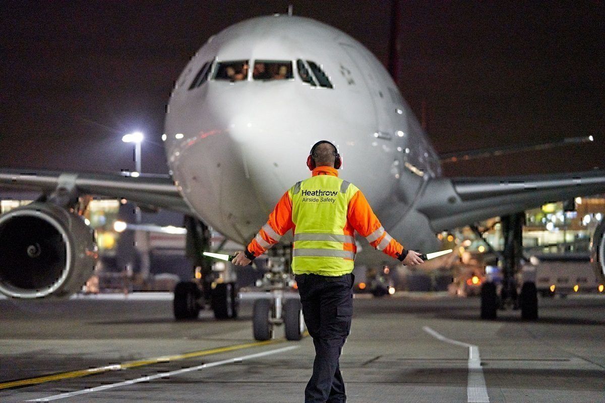 Heathrow Airport marshal in action