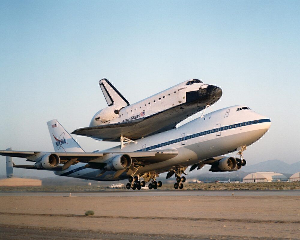 NASA N905NA taking off with a space shuttle on top.