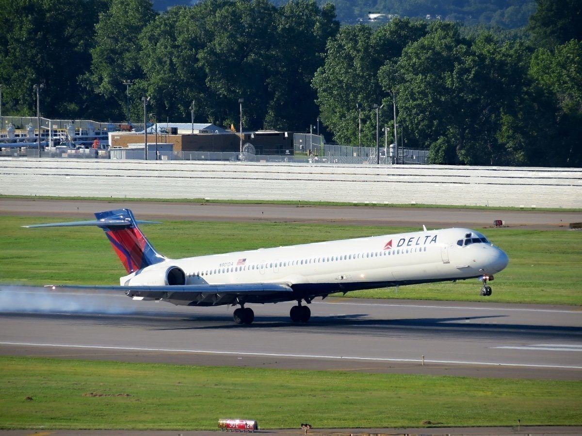 A Delta Air Lines MD-90 airliner landing on an unspecified runway.