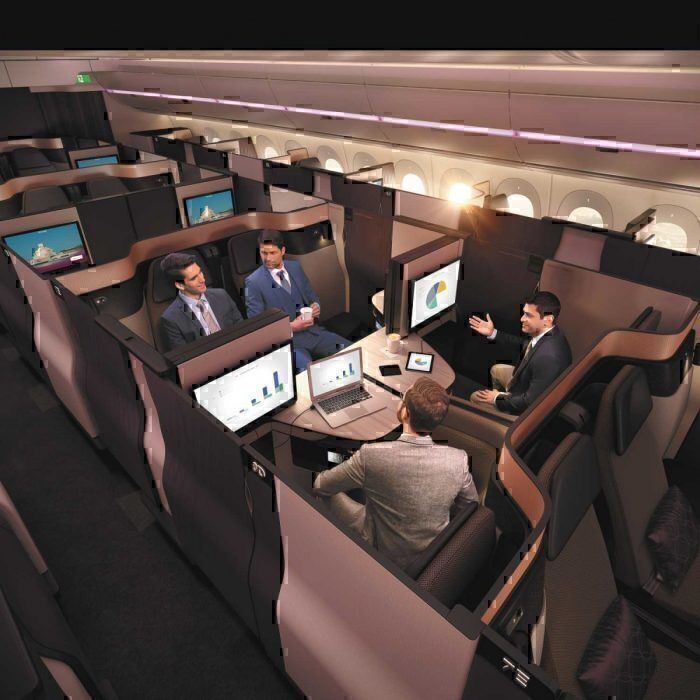 Four passengers having a conference in the Qatar Ariways Qsuite cabin.