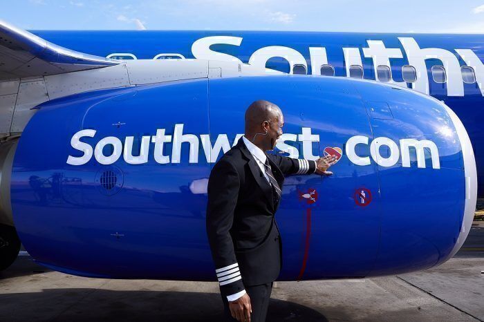 Pilot in front of southwest airlines jet