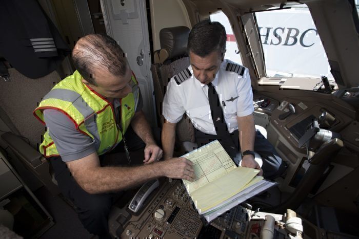 AA airline staff reviewing data
