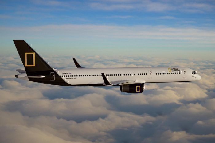 The National Geographic Boeing 757 flying in the sky.