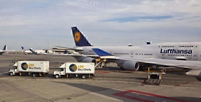 Lufthansa aircraft behind LSG Catering Trucks