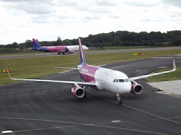 Wizz Air Airbus 320 navigates the tarmac with another Wizz Air plane in the background