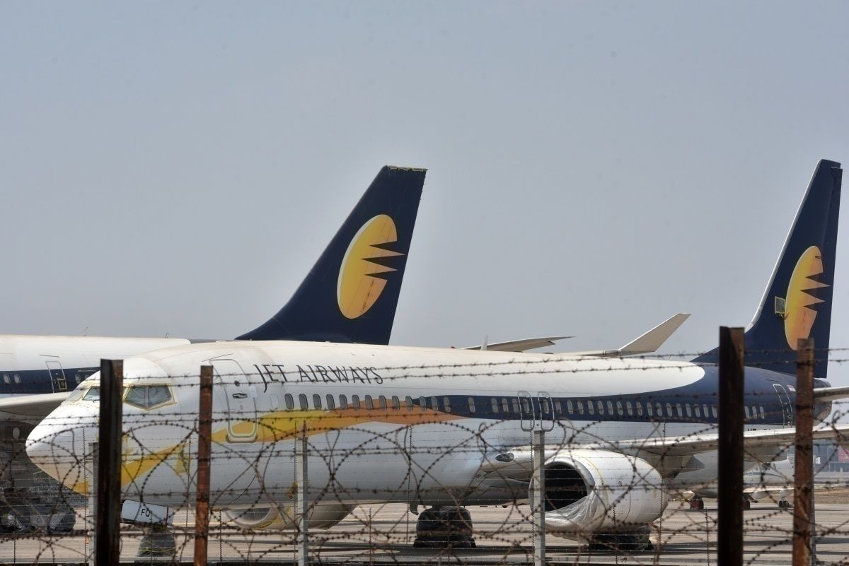 Jet airways aircraft at airport behind barbed wire fence