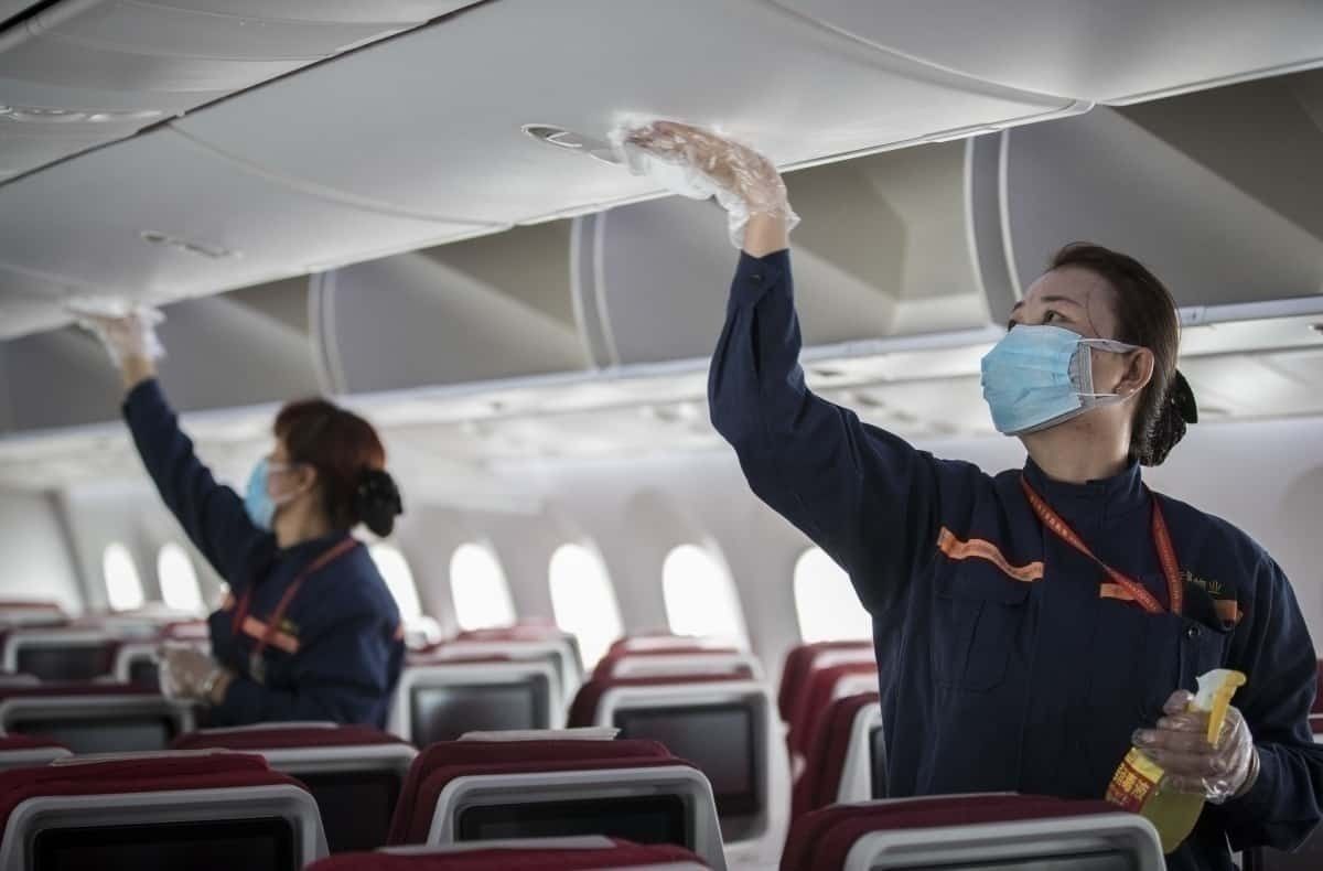 Cabin crew disinfect aircraft