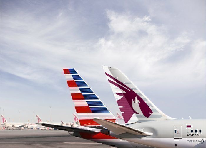 Qatar Airways and American Airlines aircraft tails next to each other.