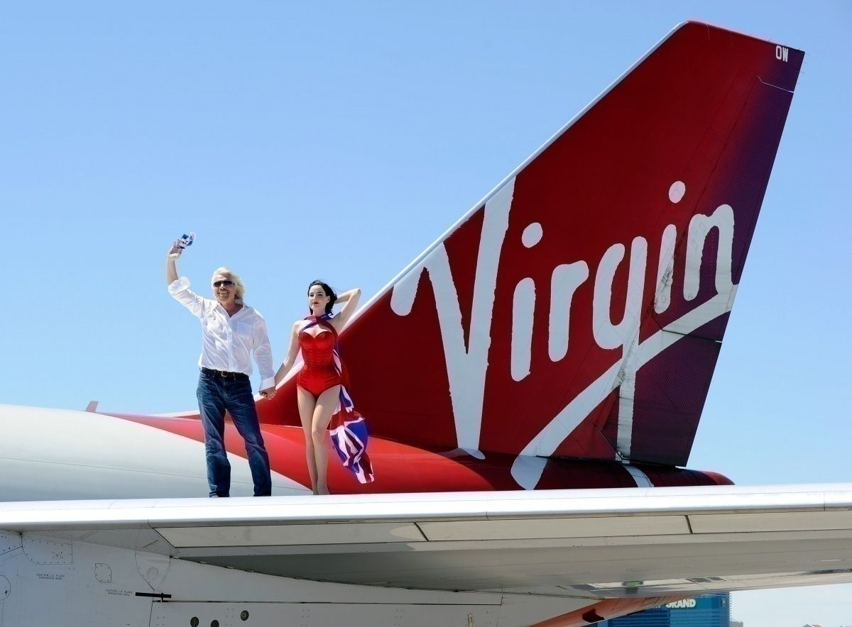 Branson and cabin crew on aircraft wing