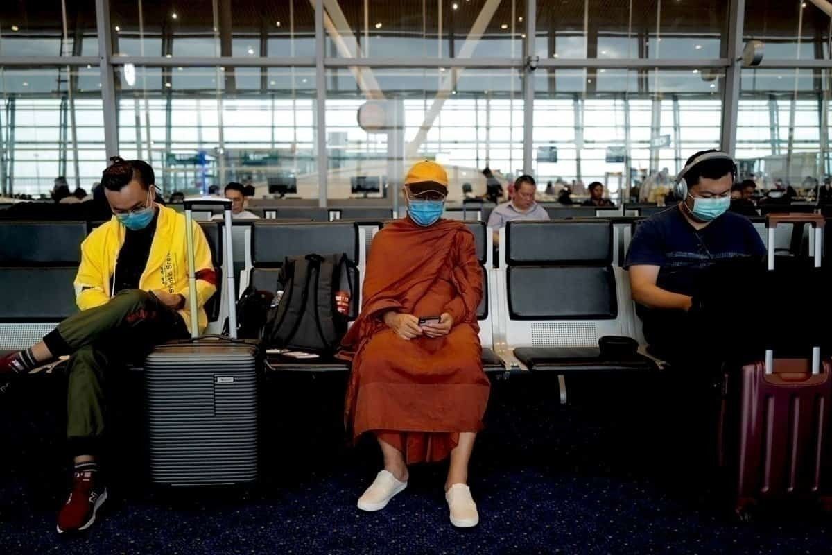 People sit apart with face masks