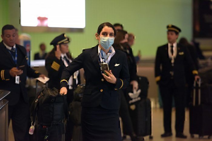 Flight attendant wearing mask