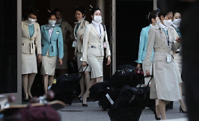 Cabin crew wears protective gear for Korean Air