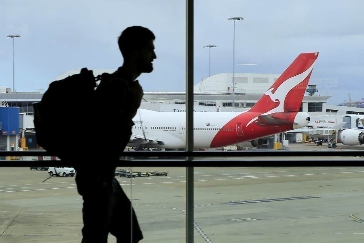Passenger walks near Qantas flight