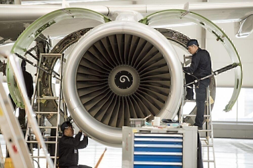 Chinese labourers work at the distribution chain for jet engines as French Prime Minister Manuel Valls visits an Airbus factory in Tianjin