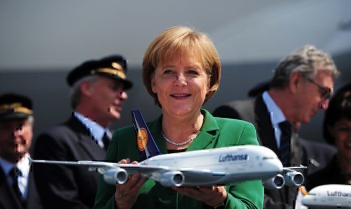 Angela Merkel holds Lufthansa plane model