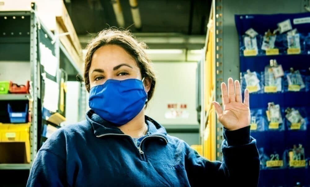 Female United employee wears face mask