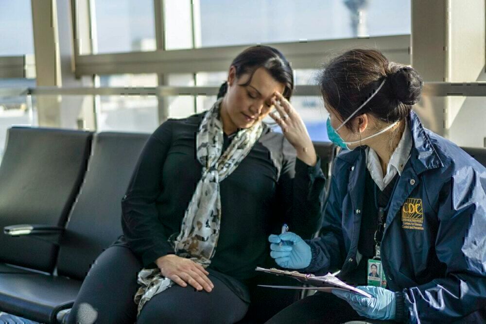 Health worke and sick passenger at airport