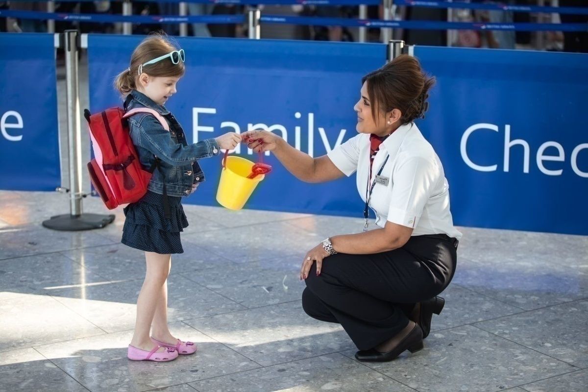 Child with bucket with BA staff member