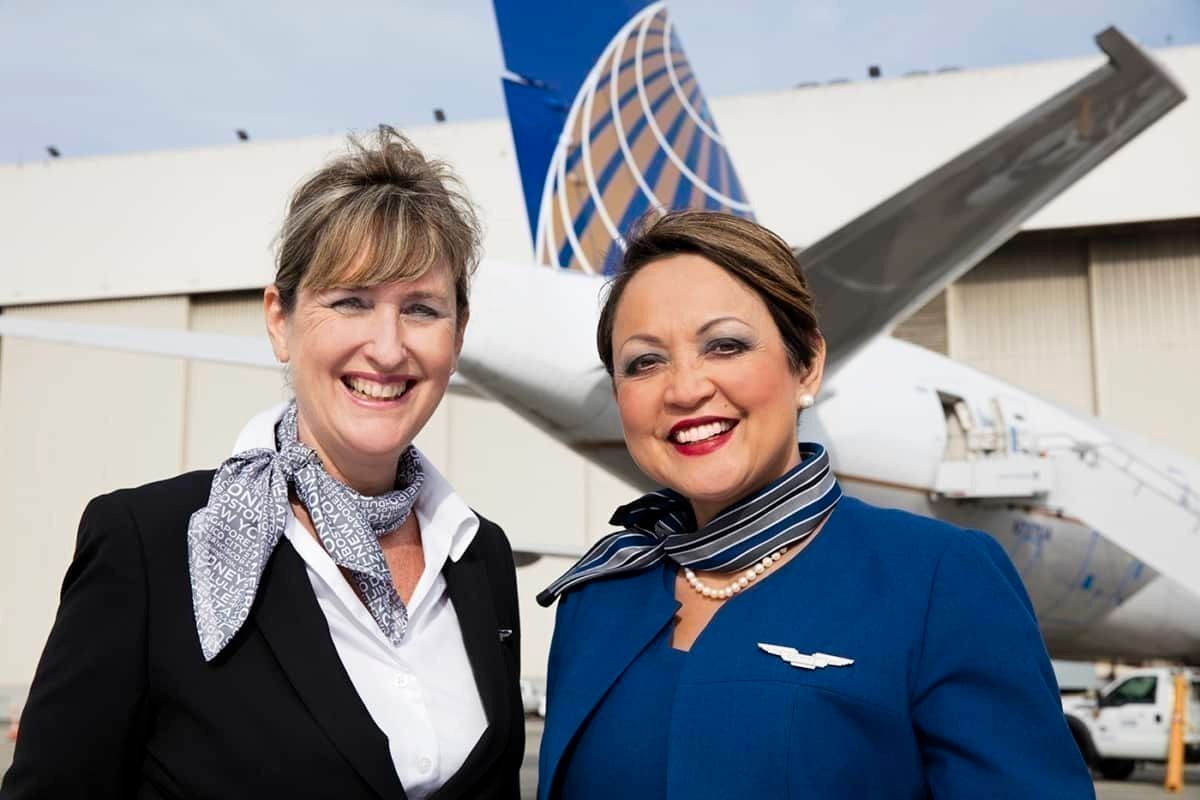 two femal flight attendants near aircraft
