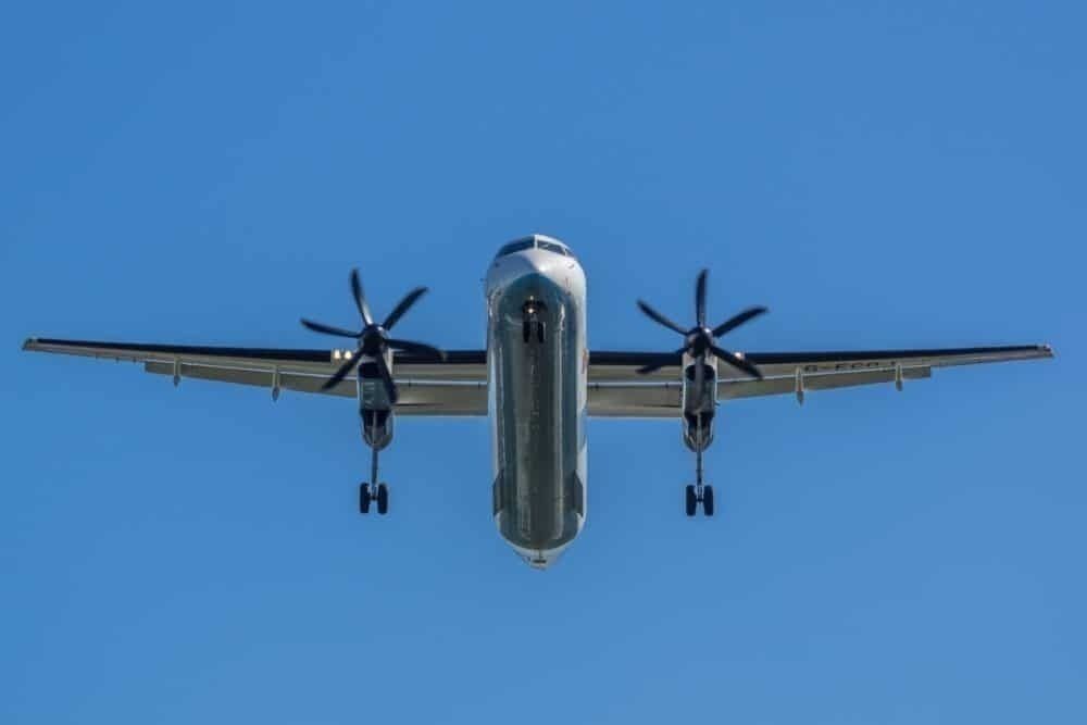 A Bombardier Dash 8 Q400 flying in the sky.