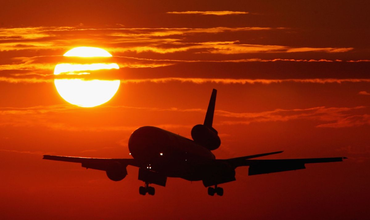 Plane with sun at sunset