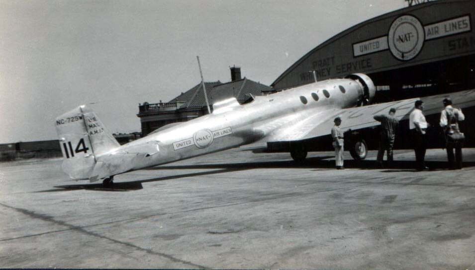 A Boeing Monomail parked near a hangar.