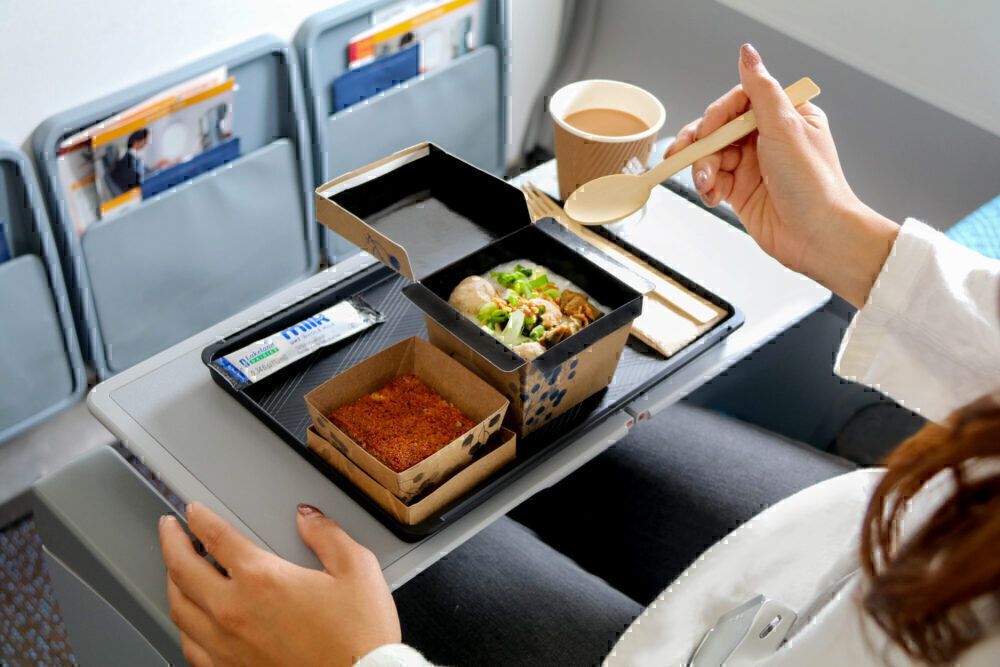 Passenger enjoying a meal onboard a Singapore Airlines short-haul flight.