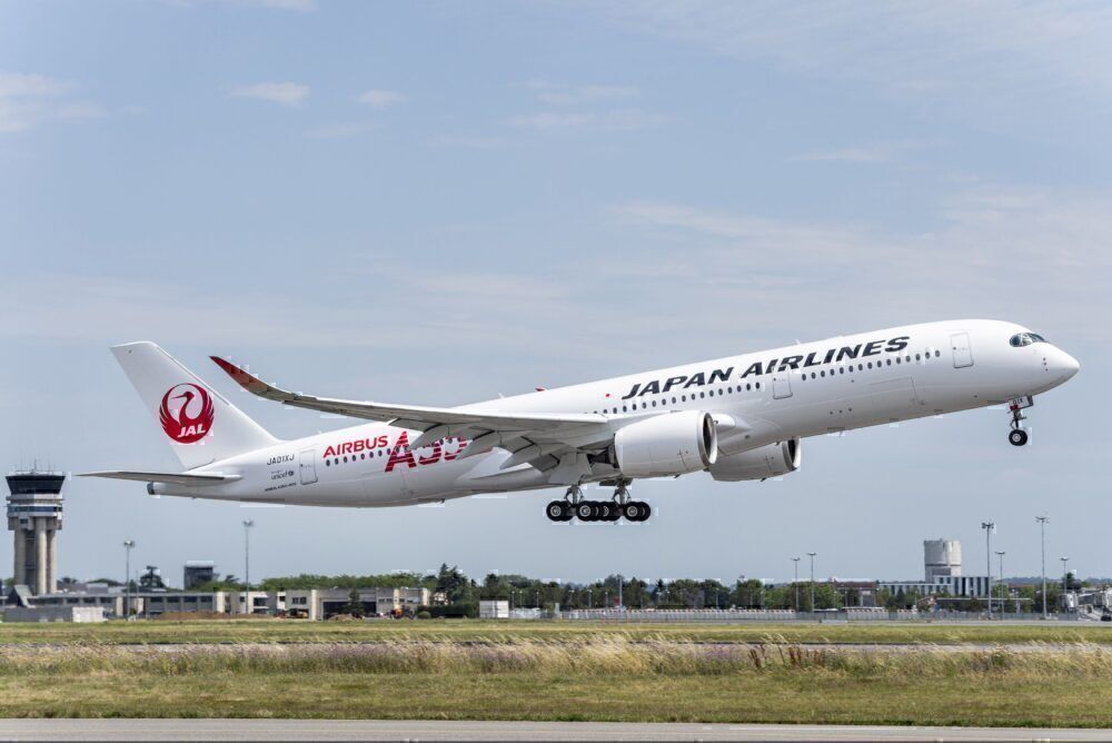 Japan Airlines A350-900 taking off from a runway.