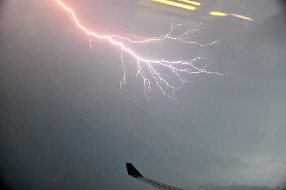 Lightning outside plane window