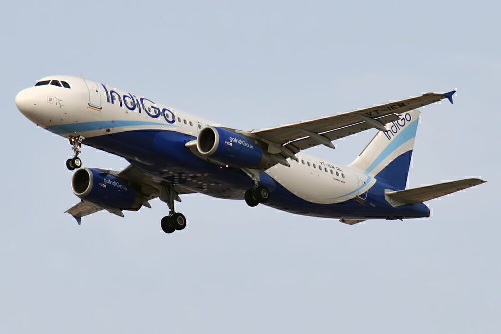 An IndiGo A320-200 flying in the sky.