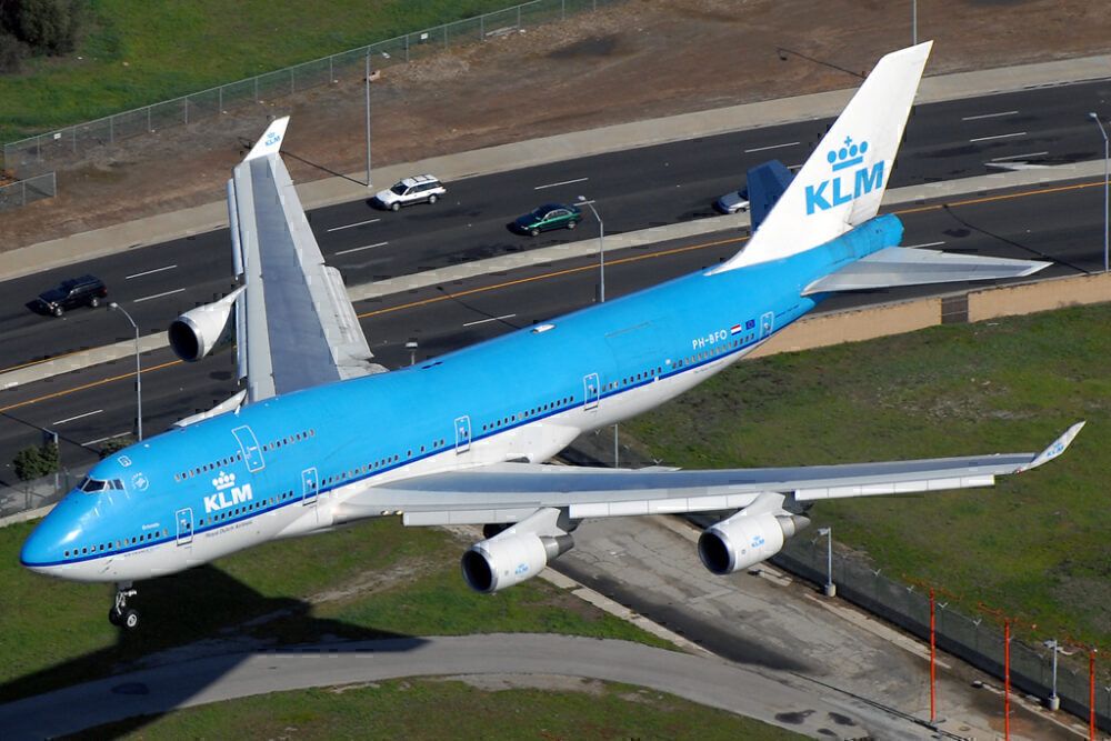 A KLM Boeing 747-400M Combi about to land at an airport.