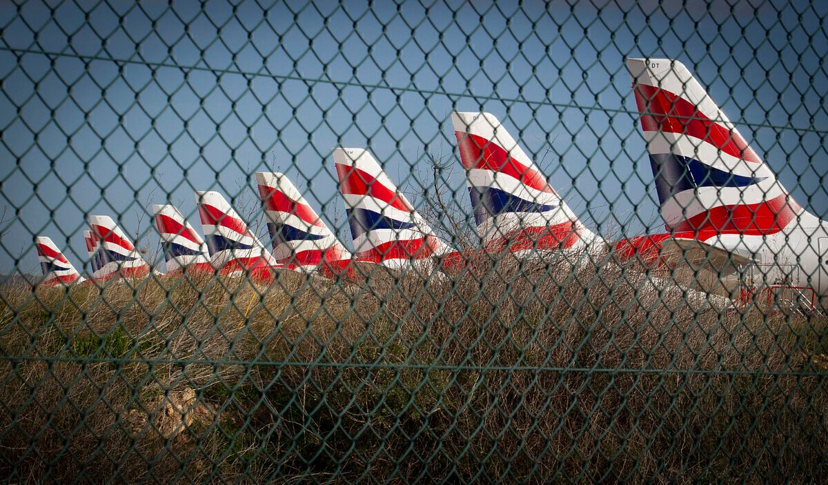 British Airways planes parked behind a fence