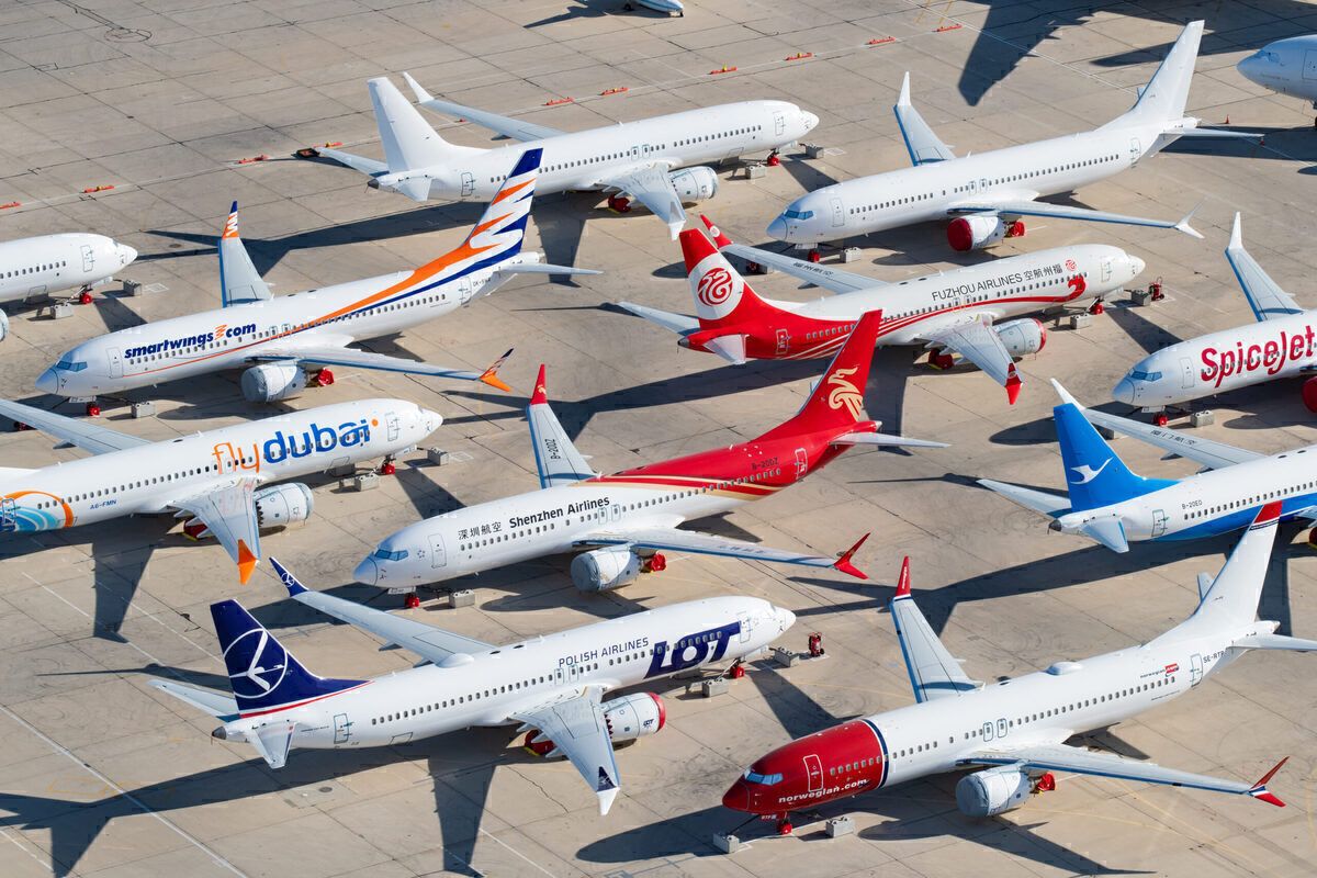 Several aircraft from many different carriers parked at an airport.