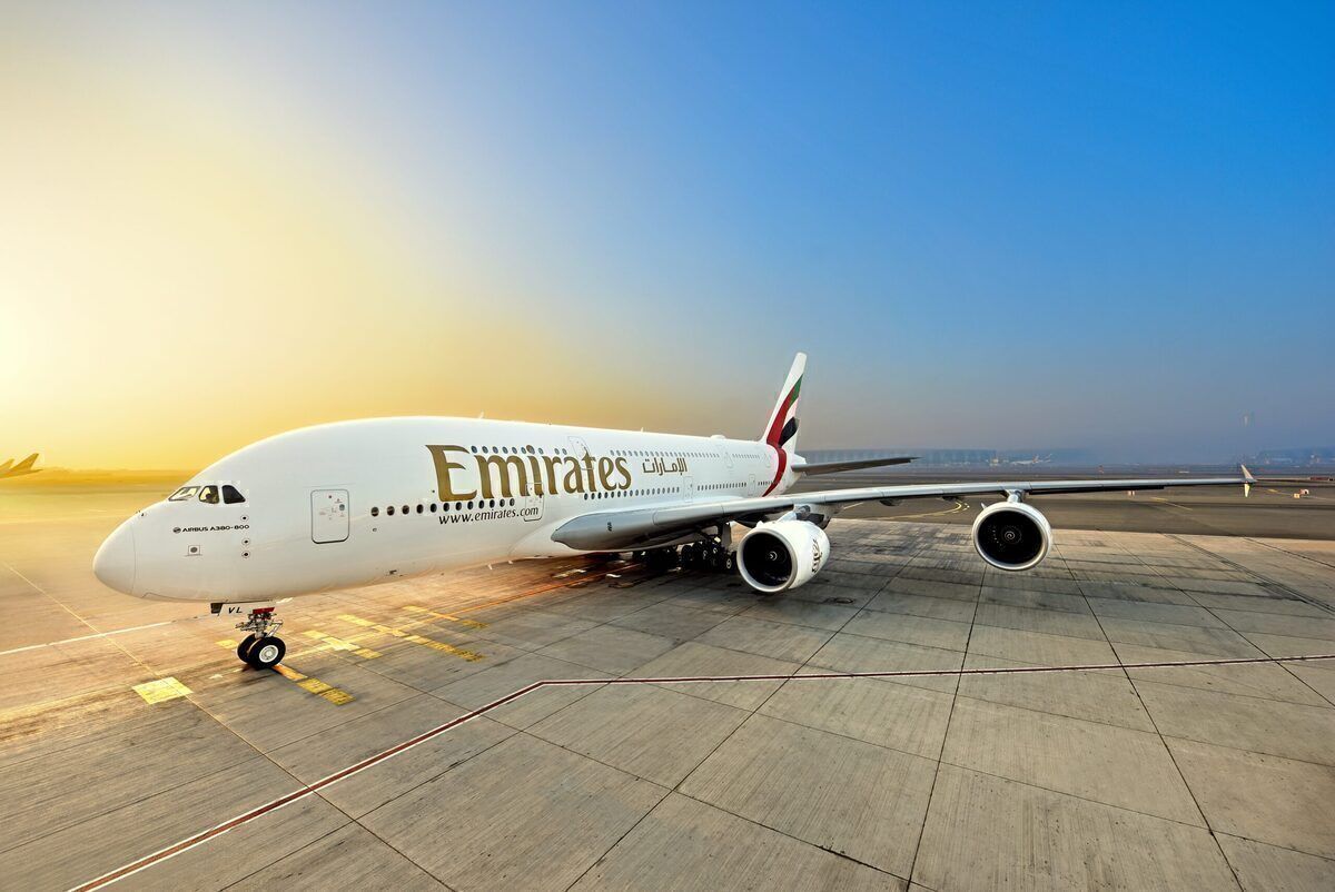 An Emirates Airbus A380 in front of the sunset