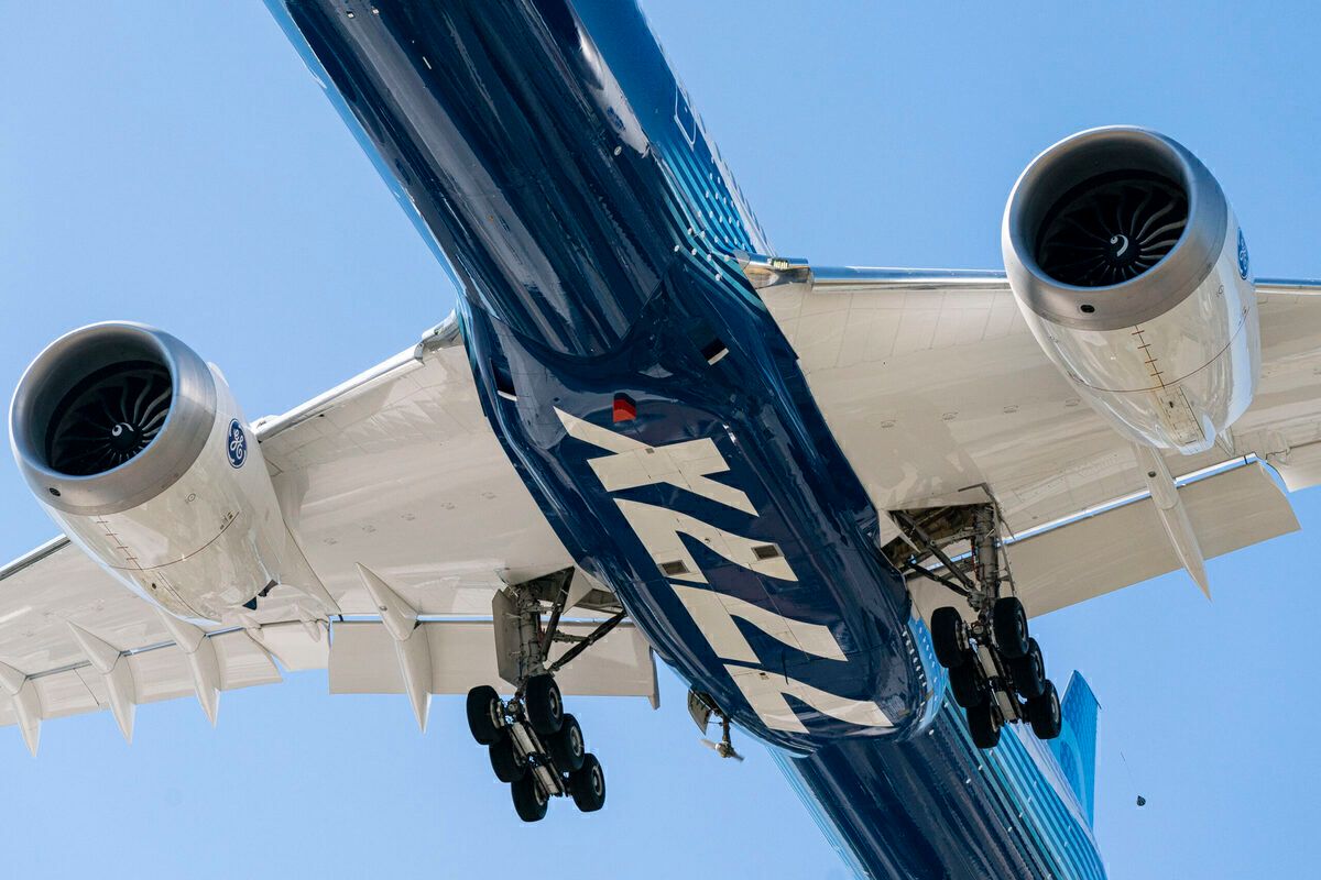 Bottom up shot of a Boeing 777X passing overhead