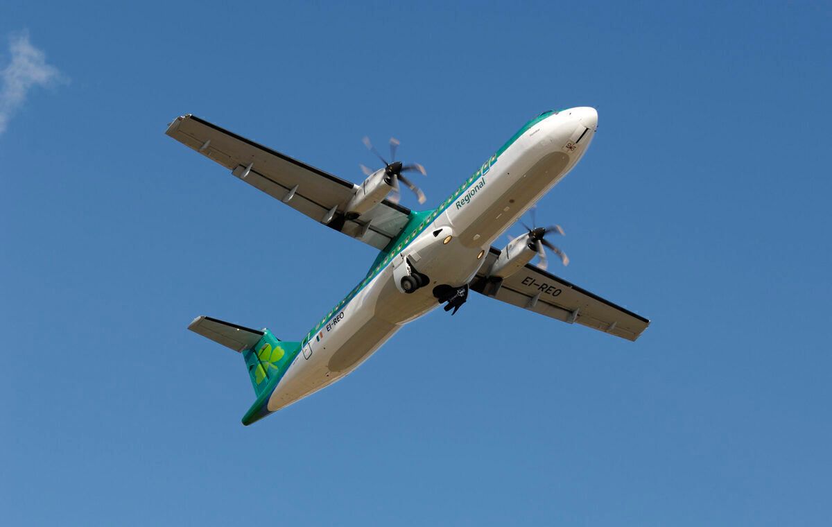 Aer Lingus Regional - Aer Arann ATR 72-500 climbing out after take-off with undercarriage retracting