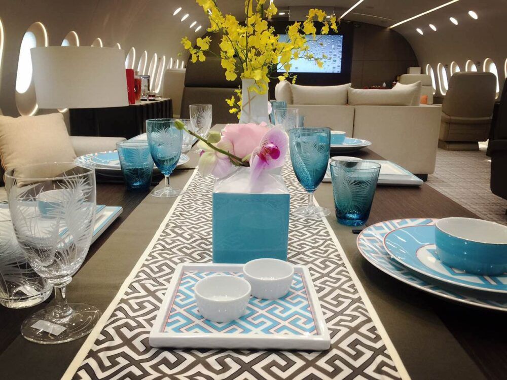 A dining table set up for service onboard a private 787.
