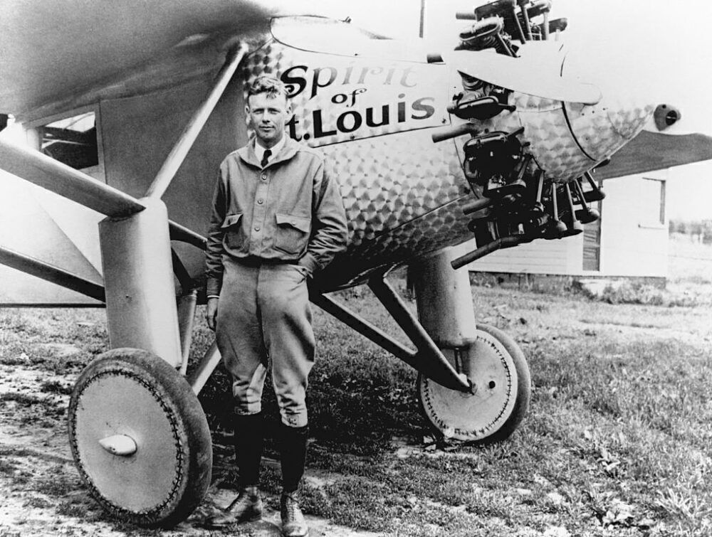 Charles Lindbergh standing near his Ryan monoplane, the Spirit of St Louis.