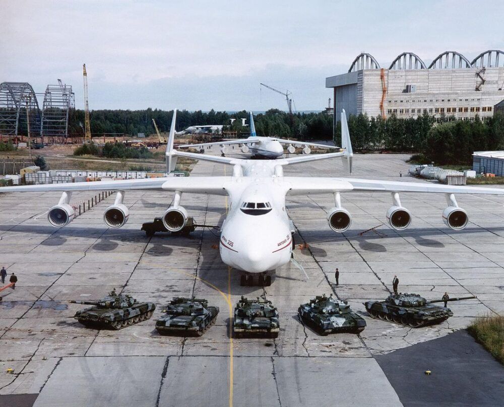 Antonov An-225 Parked Behind A Row Of 5 Tanks