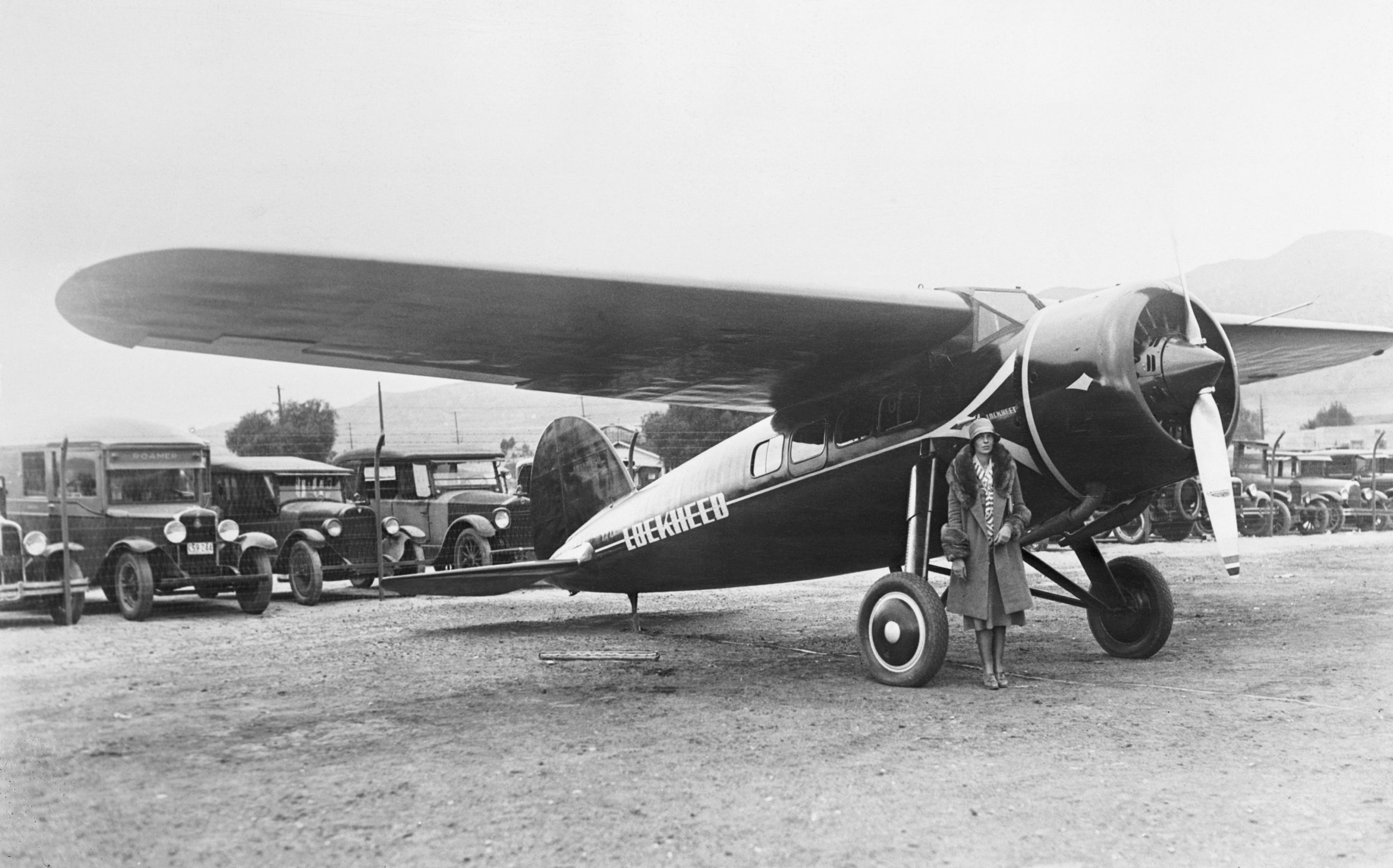 Amelia Earhart Posing Beside Plane