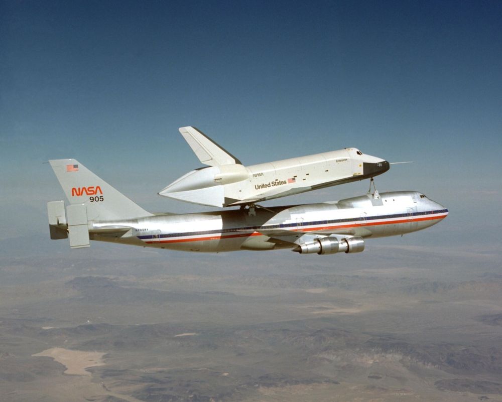 NASA’s first 747, registration N905NA, in original American Airlines livery, flying with a space shuttle on top.