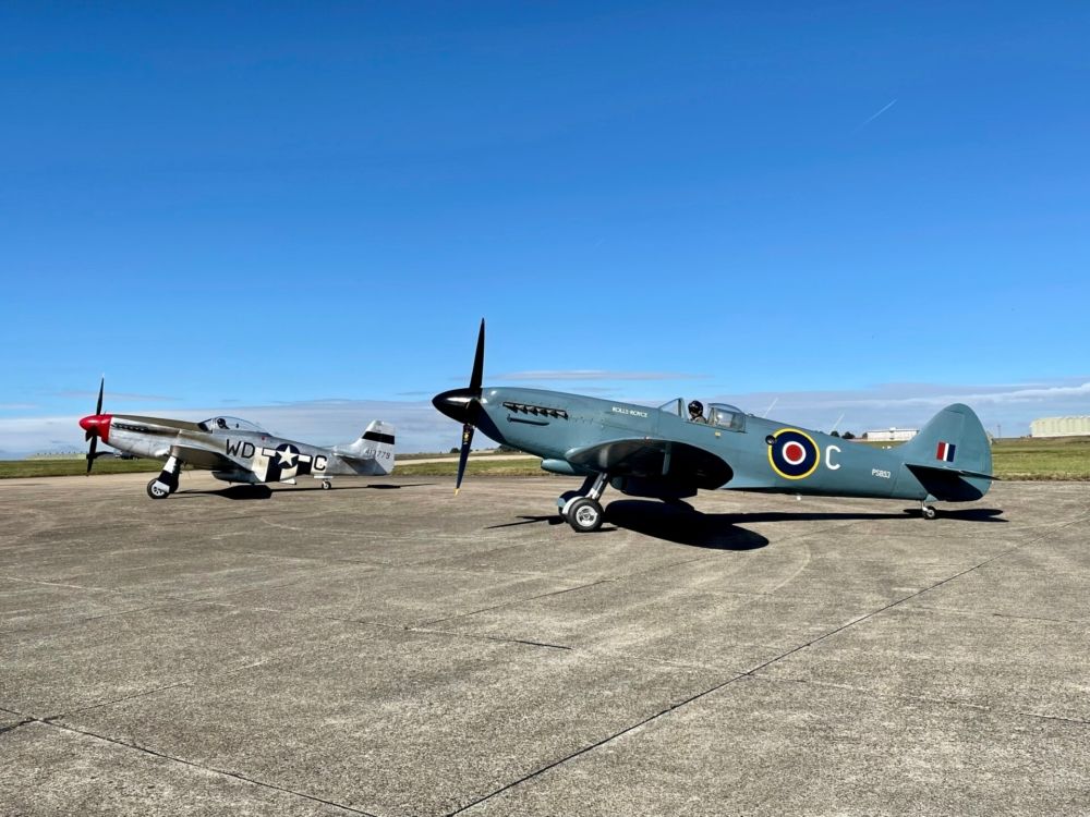 A P-51 Mustang and Supermarine Spitfire parked side by side.
