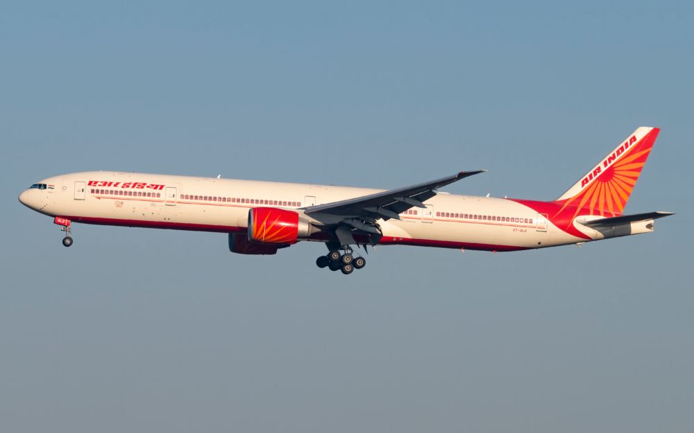 An Air India Boeing 777-337(ER) flying in the sky.