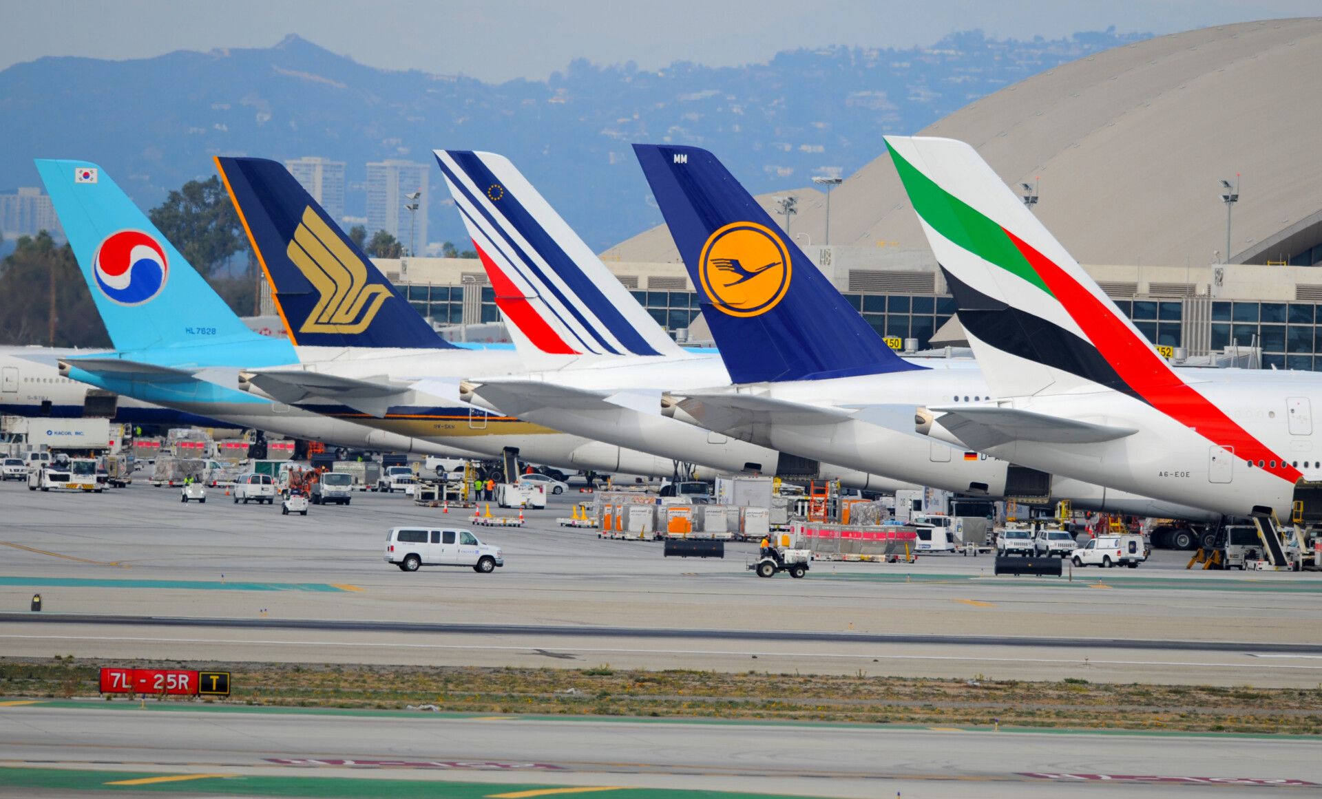 Aircraft tails of Korean Air, Singapore Airlines, Air France, Lufthansa, and Emirates.