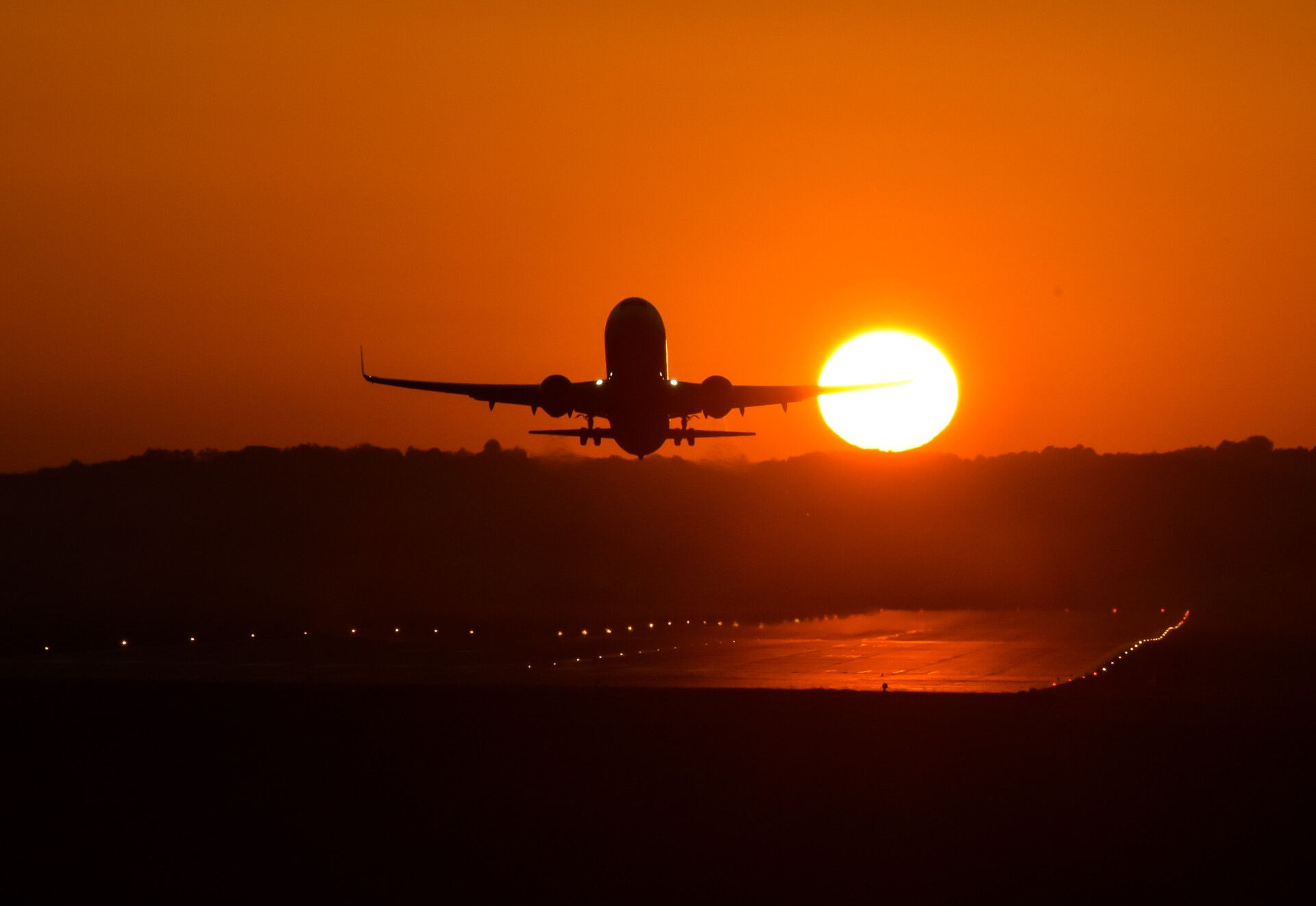 A plane seen taking off during sunset at Krakow's Balice