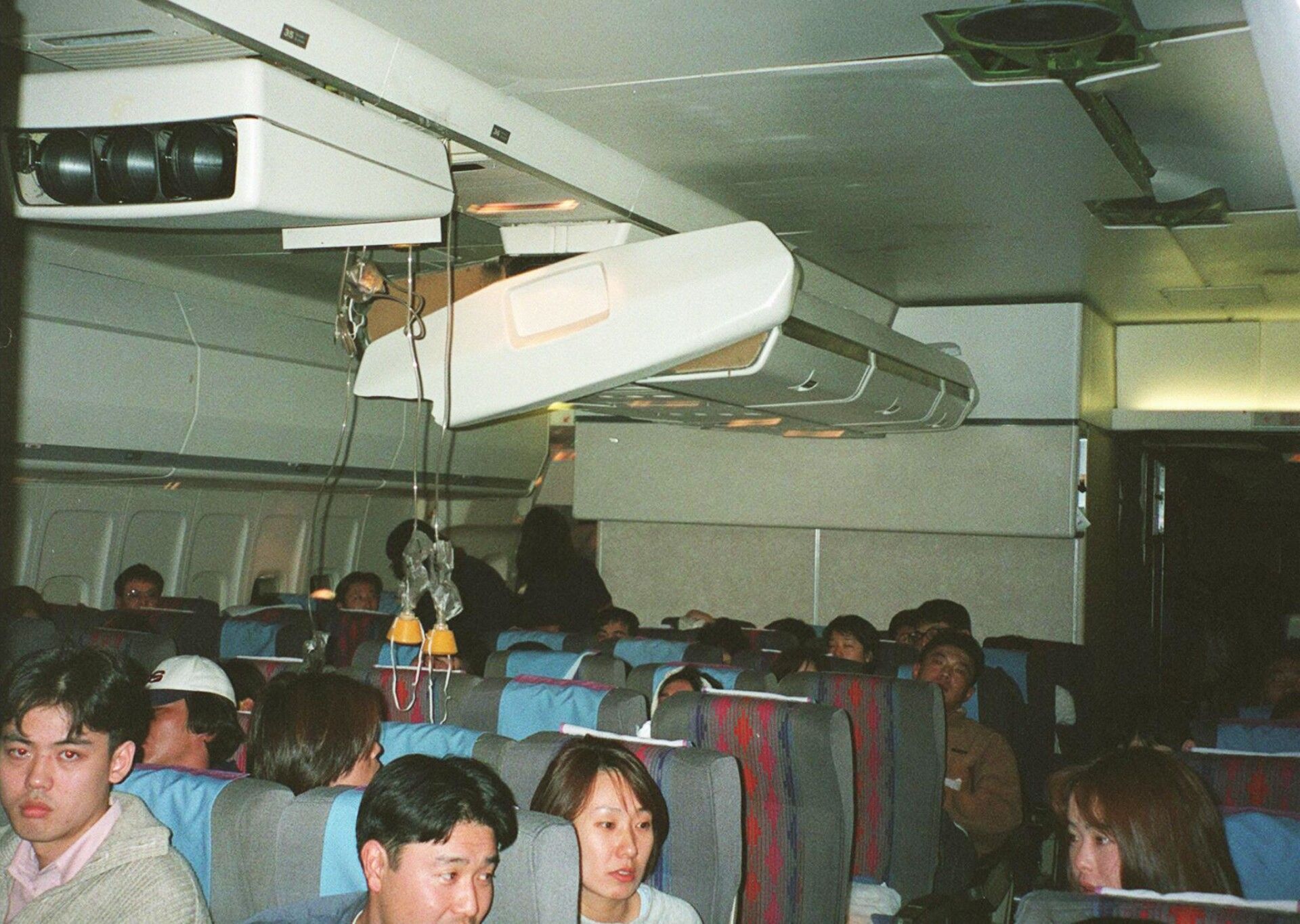 Passengers aboard United Airlines flight 826 sit u