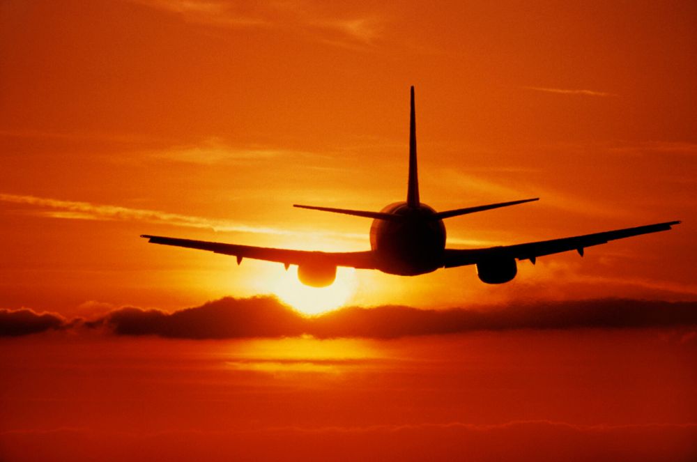 Boeing 737 flying enroute at sunset silhouette
