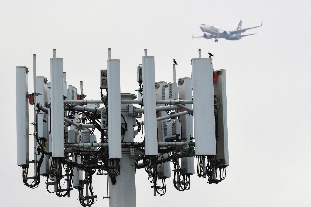 5G Tower with aircraft in background